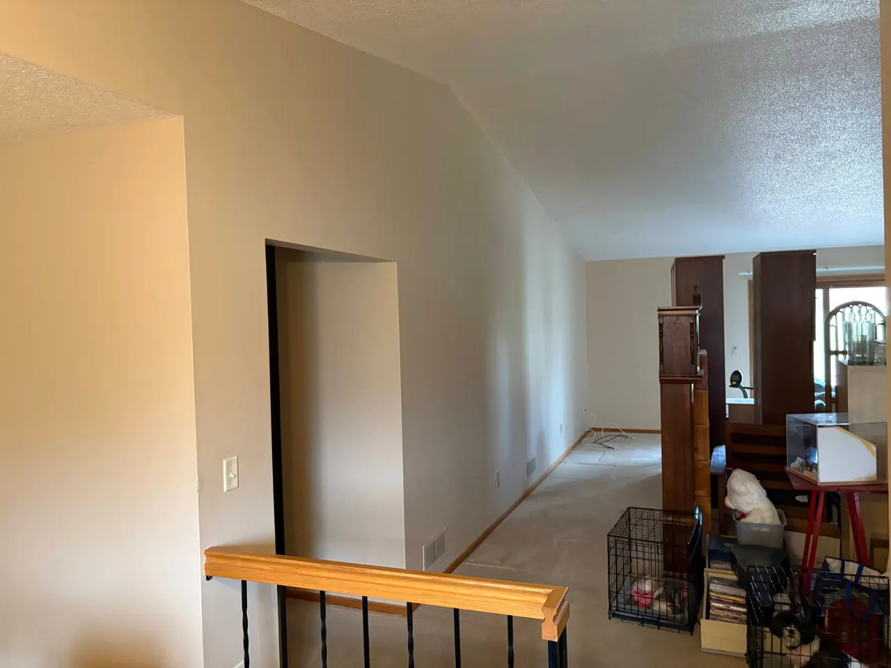 Dining area with dated beige walls and vaulted ceiling before interior painting