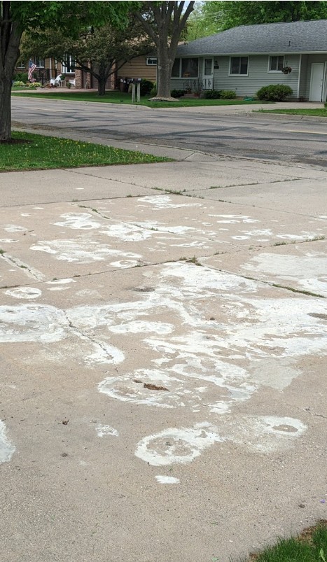 Salt-damaged concrete driveway with efflorescence in Edina, MN
