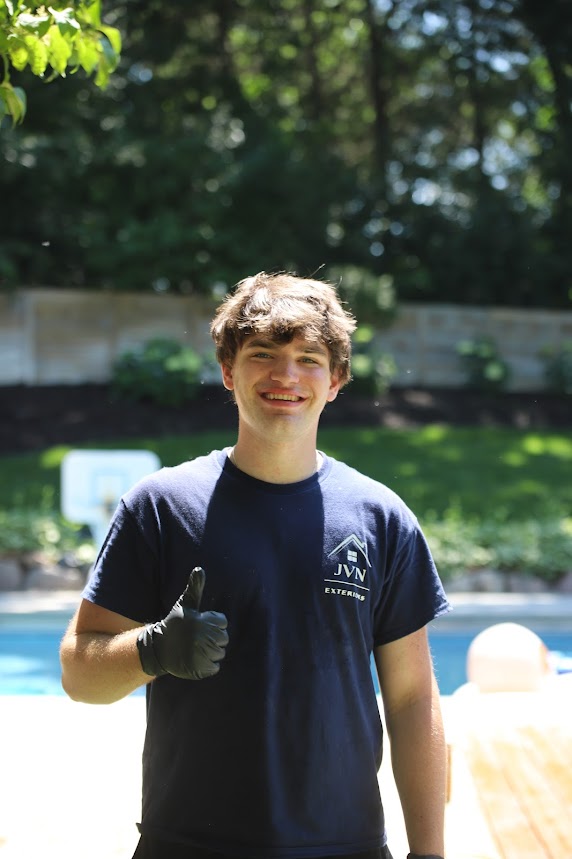 Jackson Van Nostrand, founder of JVN Exteriors, giving a thumbs up in Edina, MN