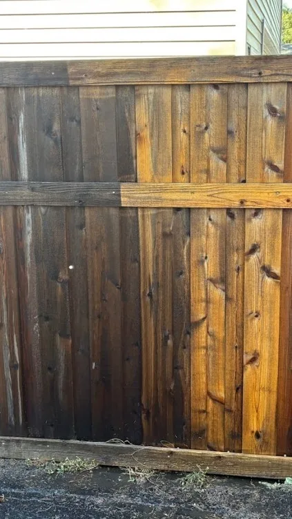 Before-and-after of a weathered gray fence cleaned to fresh natural wood in Edina, MN