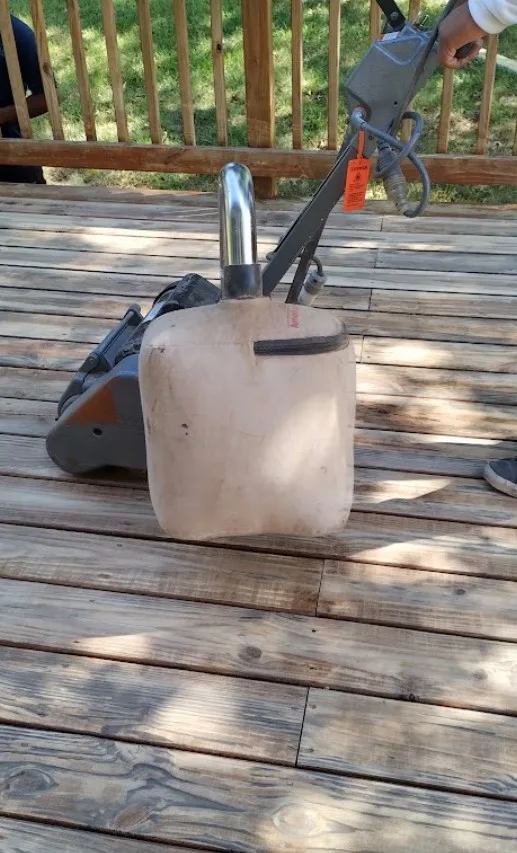 Sanding a wood deck in Edina, MN with an orbital power sander to restore a smooth surface