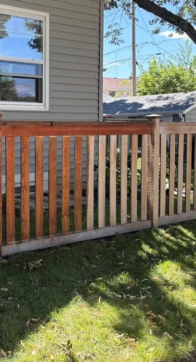 Fence refinishing in Edina with old peeling stain stripped and new rich stain applied