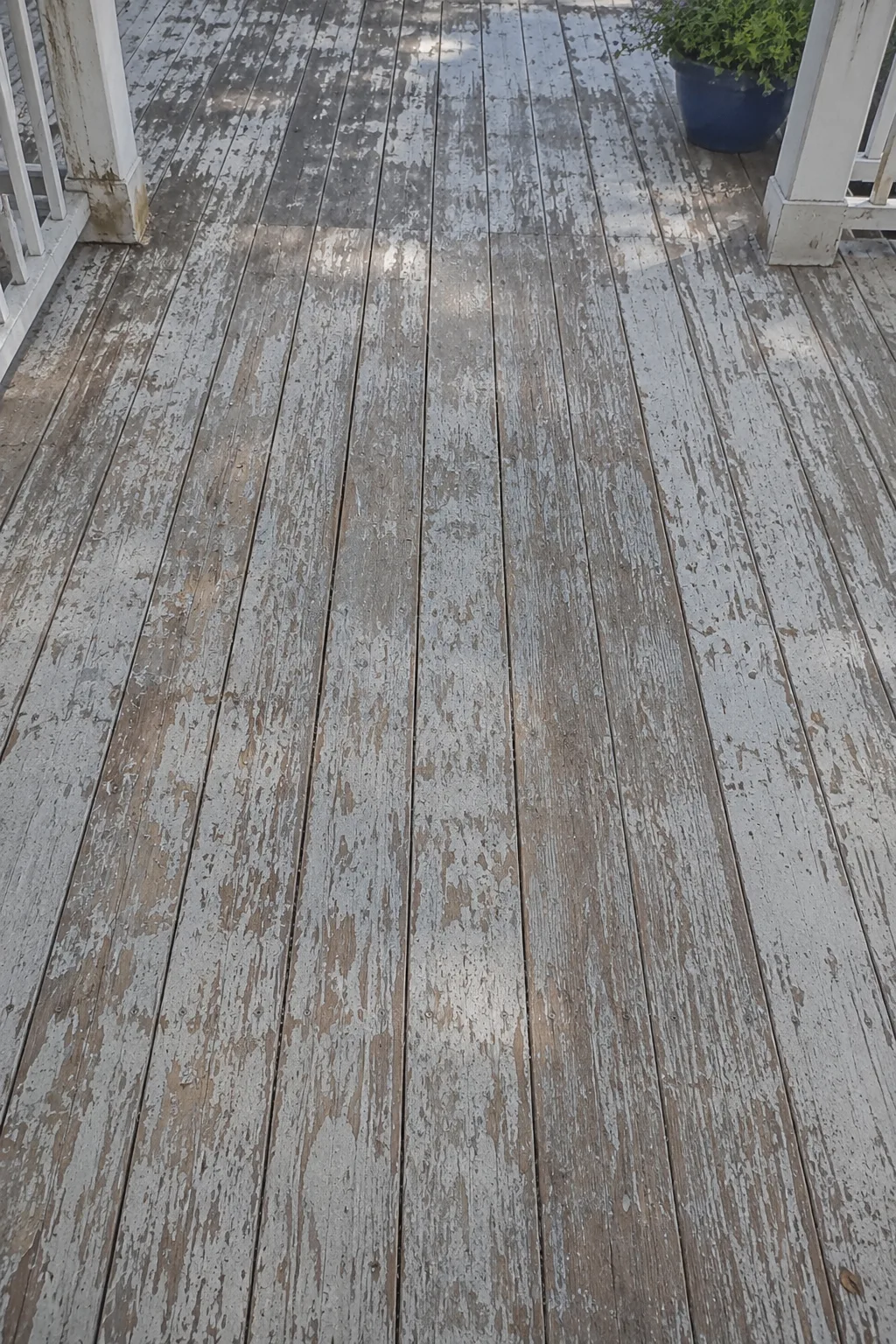 Stripping old flaking finish from a wood deck in Edina, MN down to bare wood